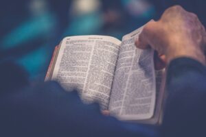 top 10 questions about christianity: person's hand holding the Bible