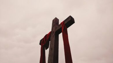 low angle view of cross with red garment - Christian perspective on Hell